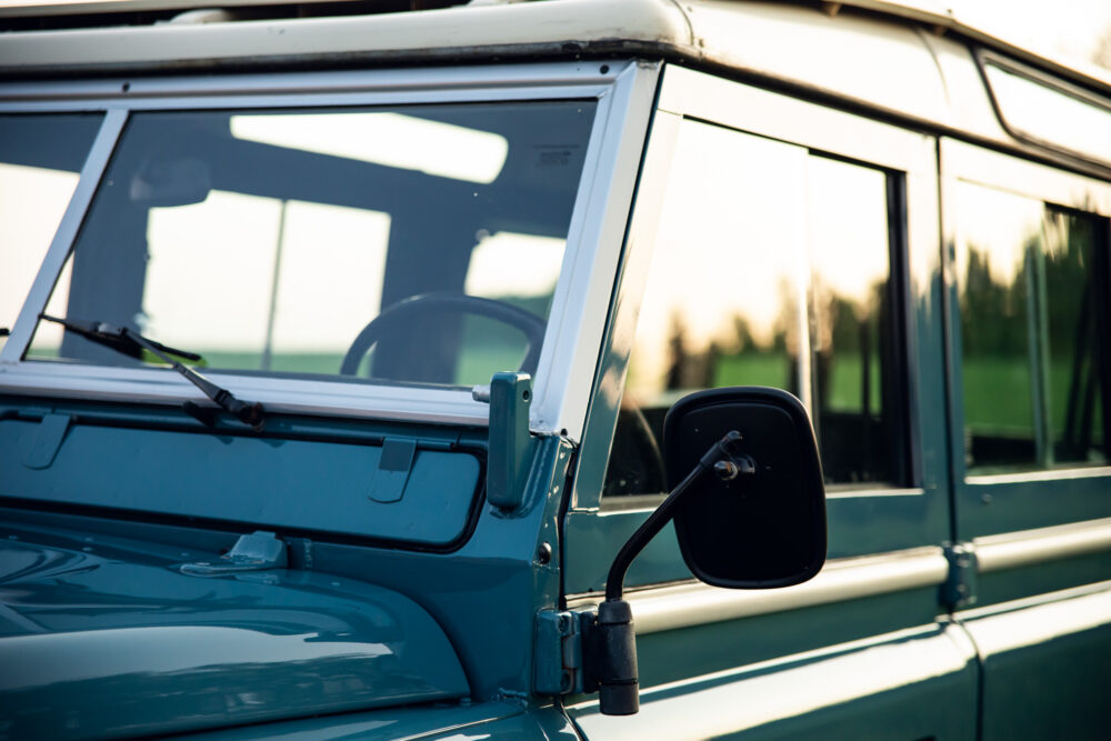 Close-up of vintage teal van's side and mirror