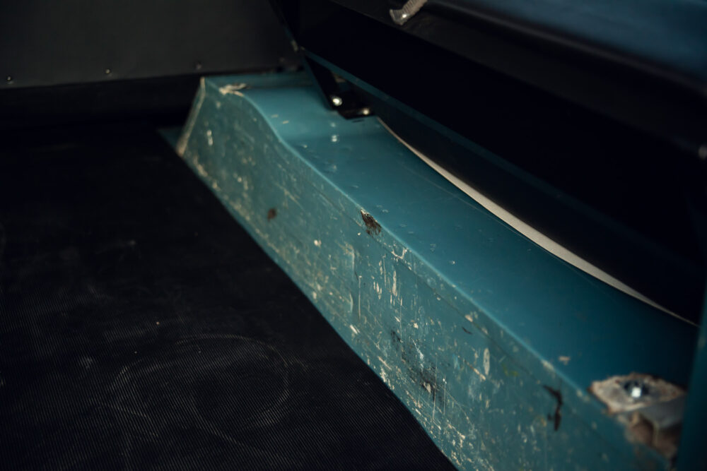 Close-up of worn blue metal surface and hardware