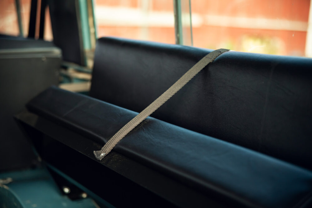 Unfastened seat belt on vintage bus seat