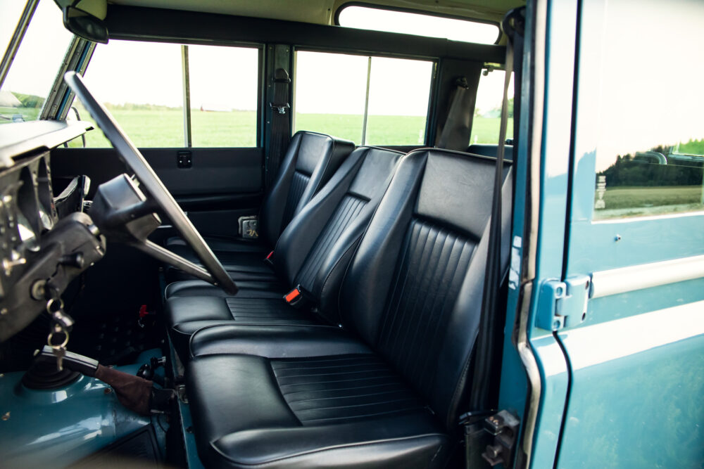 Vintage blue interior of classic car with black seats