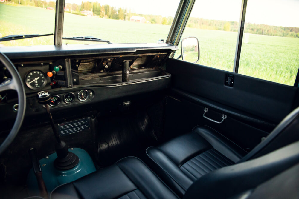 Vintage truck interior overlooking lush green field
