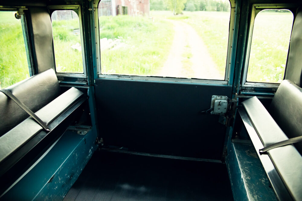 Interior of old bus with view of a country road