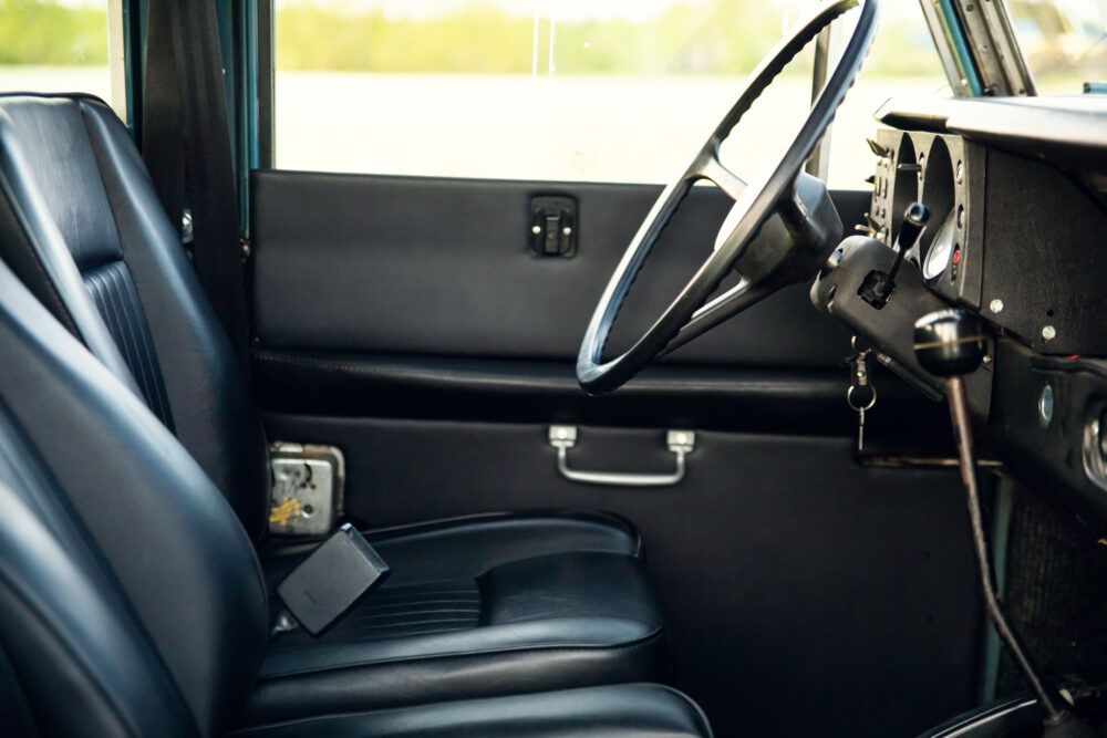 Vintage car interior with steering wheel and leather seats