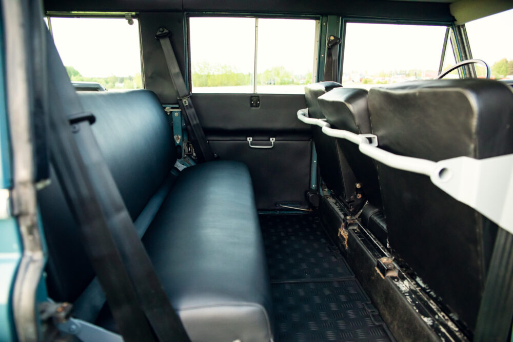 Interior view of a vintage van with blue seats