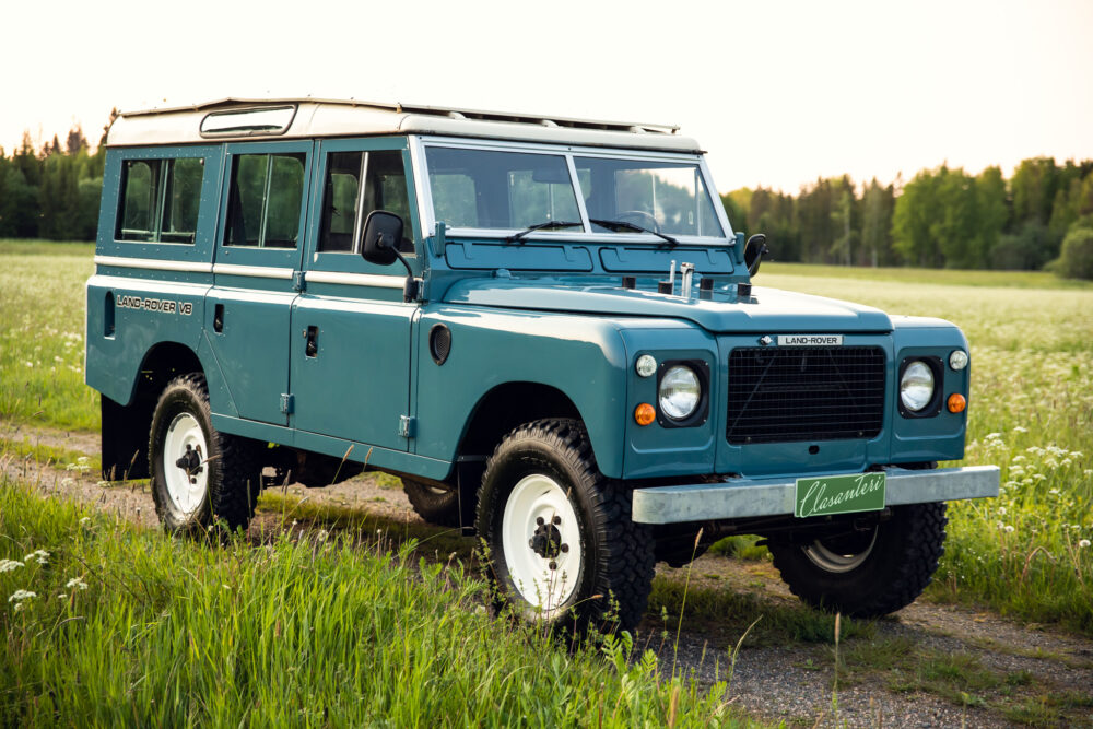 Vintage blue Land Rover on a grassy field