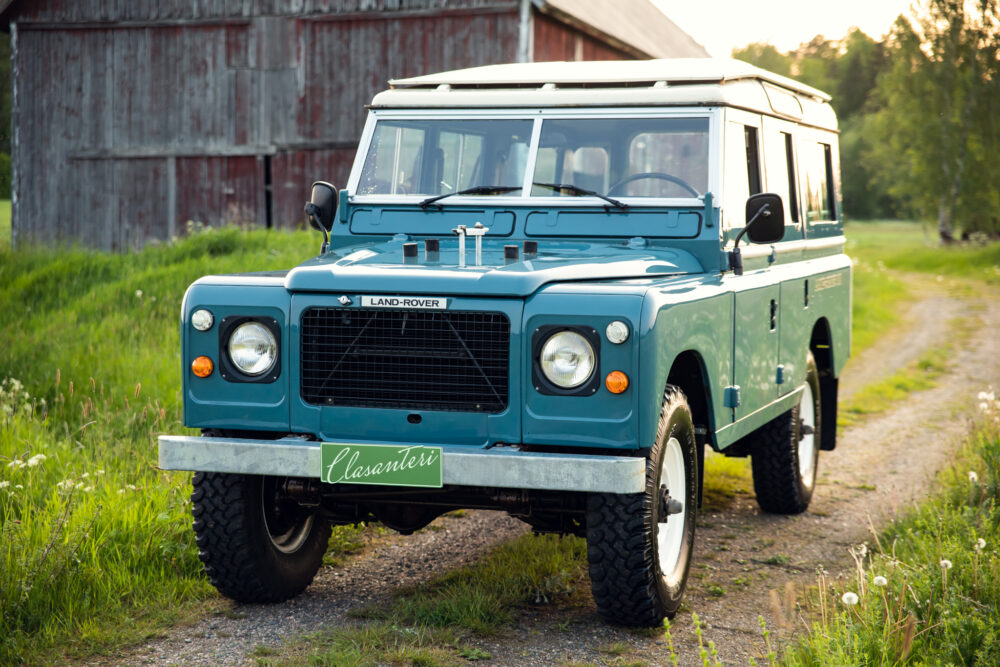 Vintage blue Land Rover on a rural path