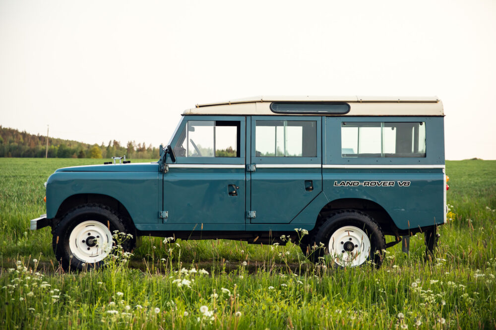 Vintage blue Land Rover V8 in a green field