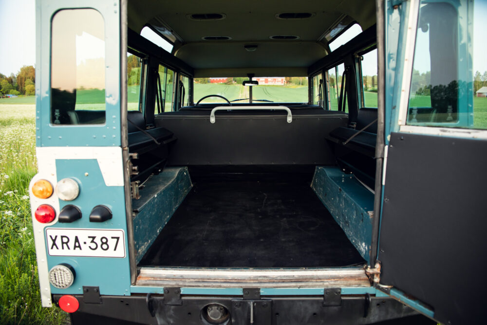 Empty interior of vintage bus with open back door