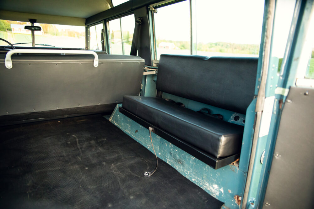 Interior view of vintage bus with empty seats.