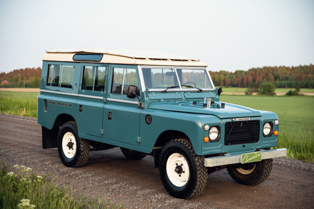 Vintage blue Land Rover on rural road