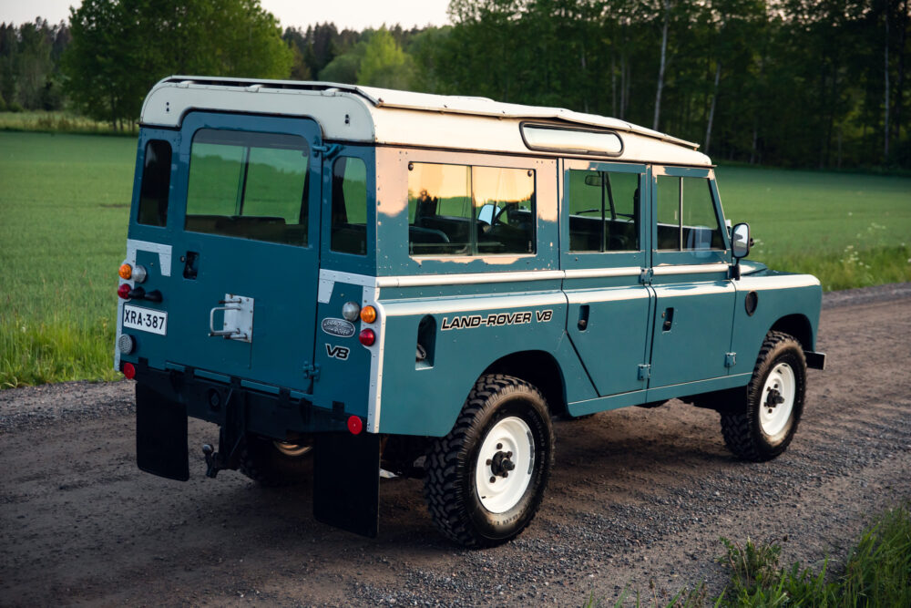 Vintage Land Rover V8 parked in rural landscape