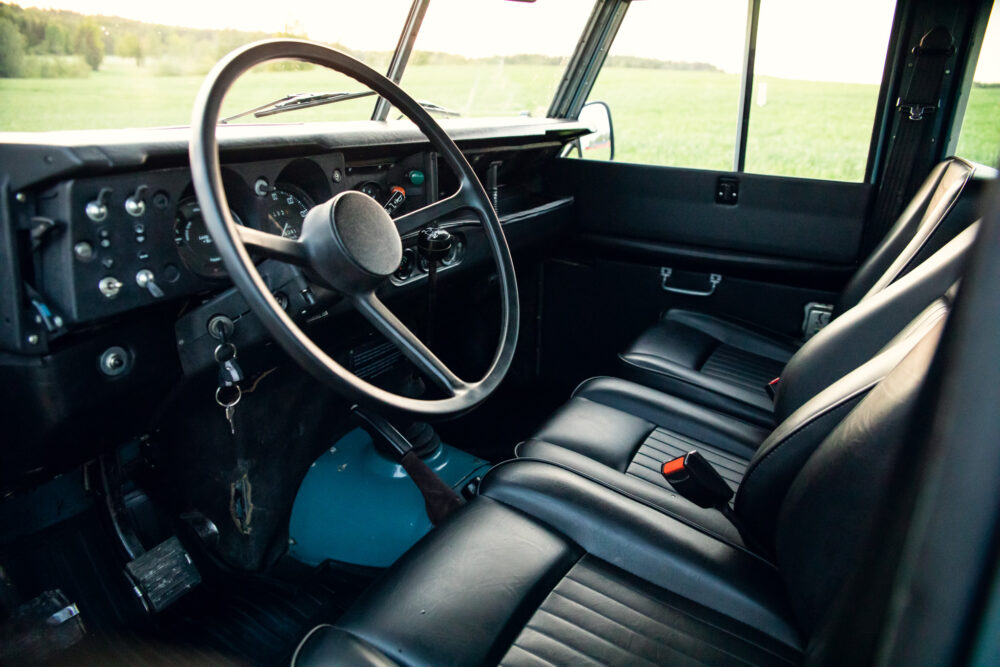 Vintage car interior with black leather seats and dashboard