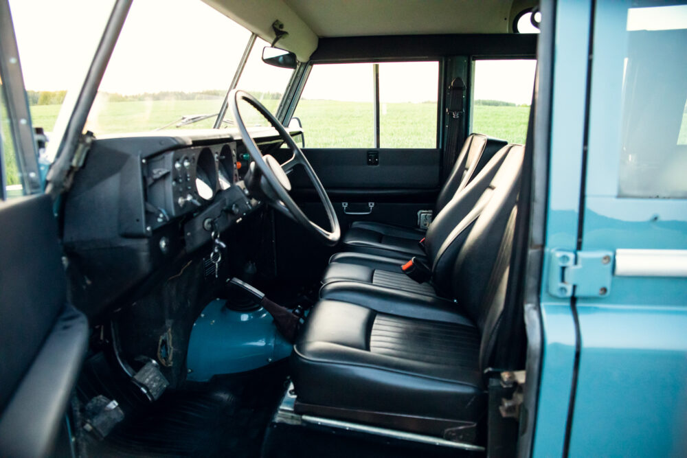 Interior view of vintage blue vehicle with black seats