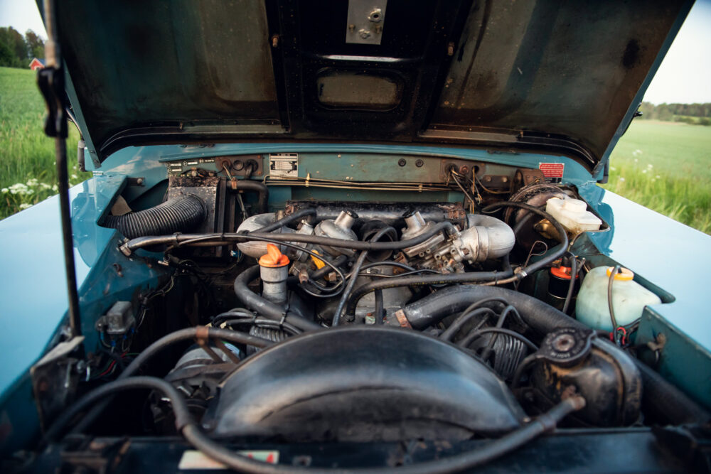 Open hood of a vintage car showing engine