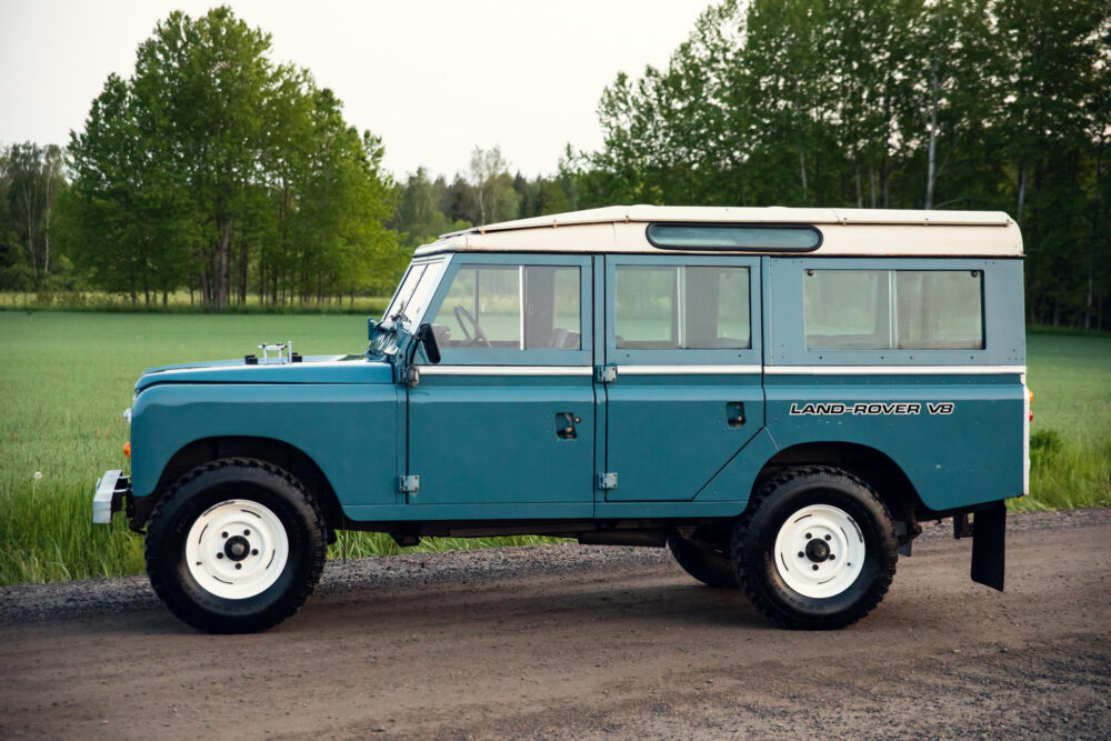 Vintage blue Land Rover V8 parked on country road