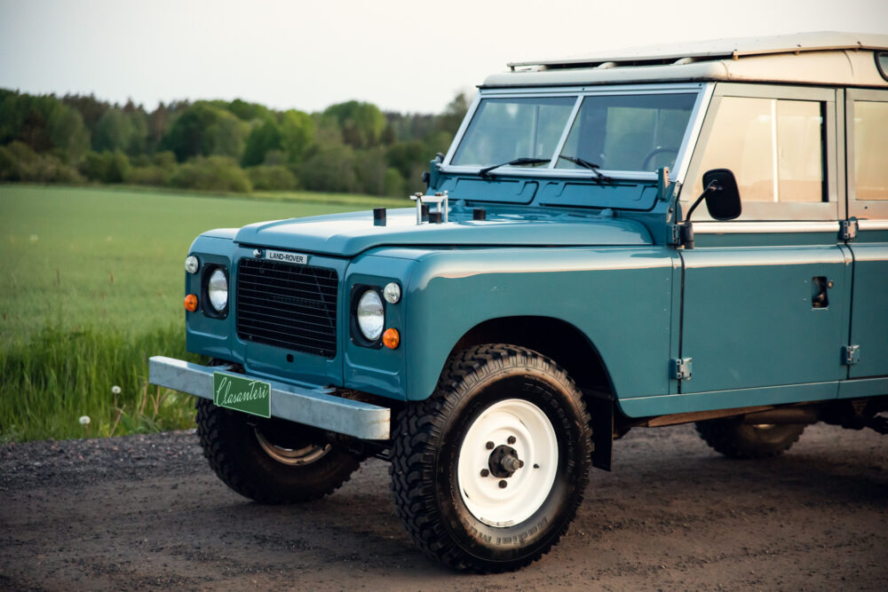 Vintage blue Land Rover on rural road