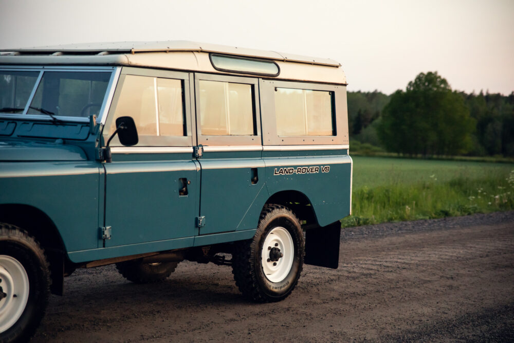 Vintage Land Rover V8 in countryside at dusk