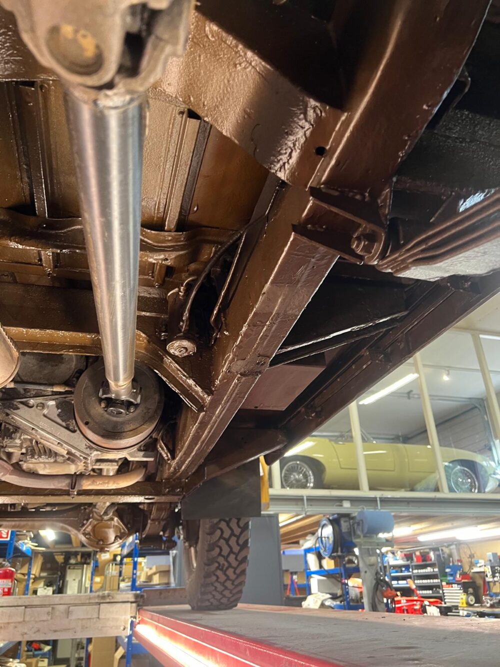 Undercarriage view of vehicle on lift in auto shop