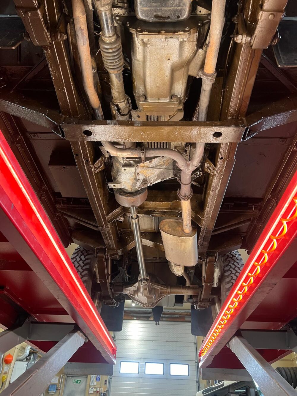 Undercarriage view of vehicle on lift in workshop