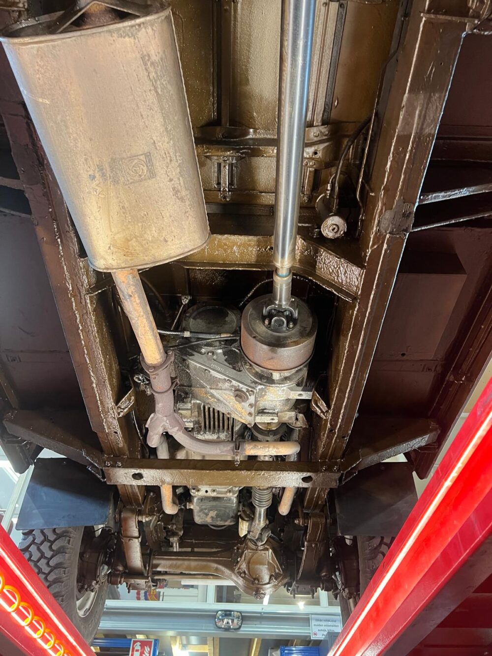 Undercarriage view of a vintage car with detailed components