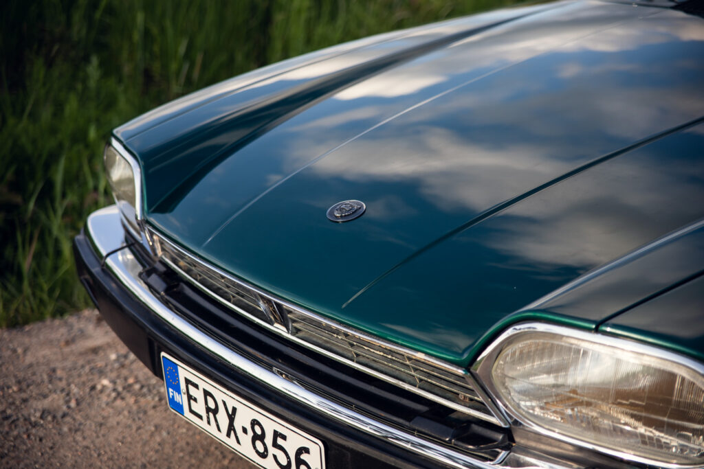 Close-up of vintage car hood and emblem