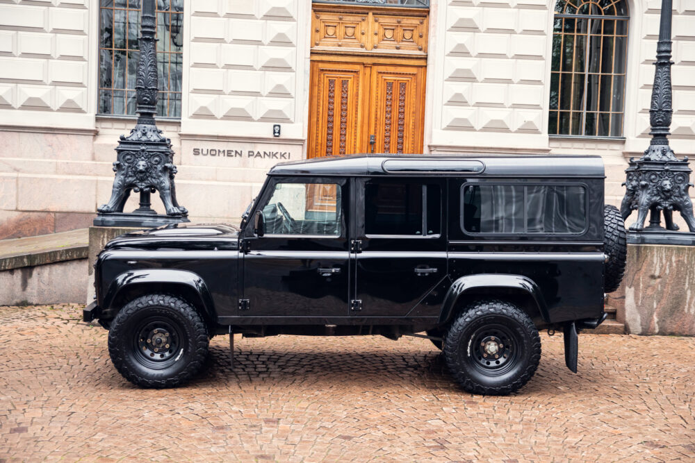 Black SUV parked outside ornate building entrance