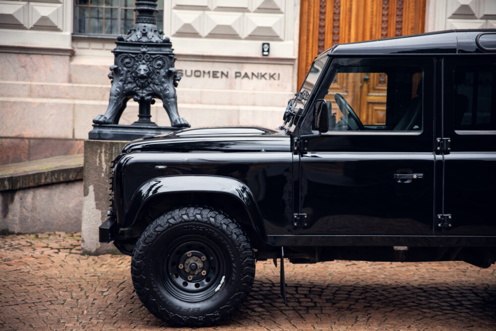 Black SUV parked near ornate lion statue