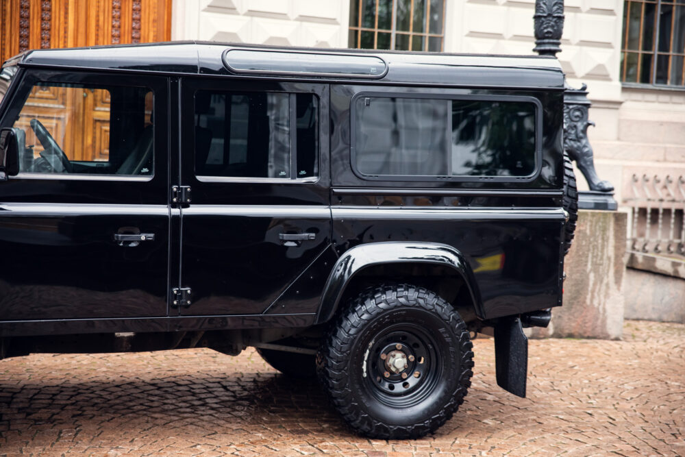 Black SUV parked near historical building