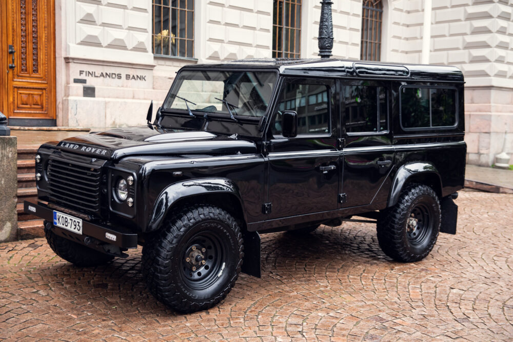 Black Land Rover Defender parked outside building