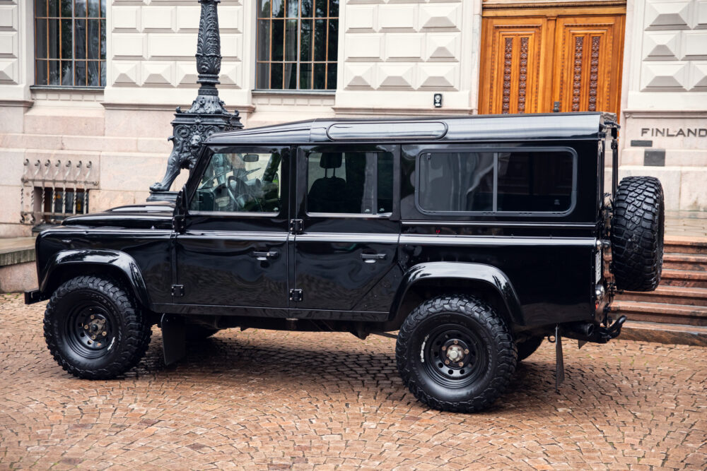Black SUV parked in front of historic building