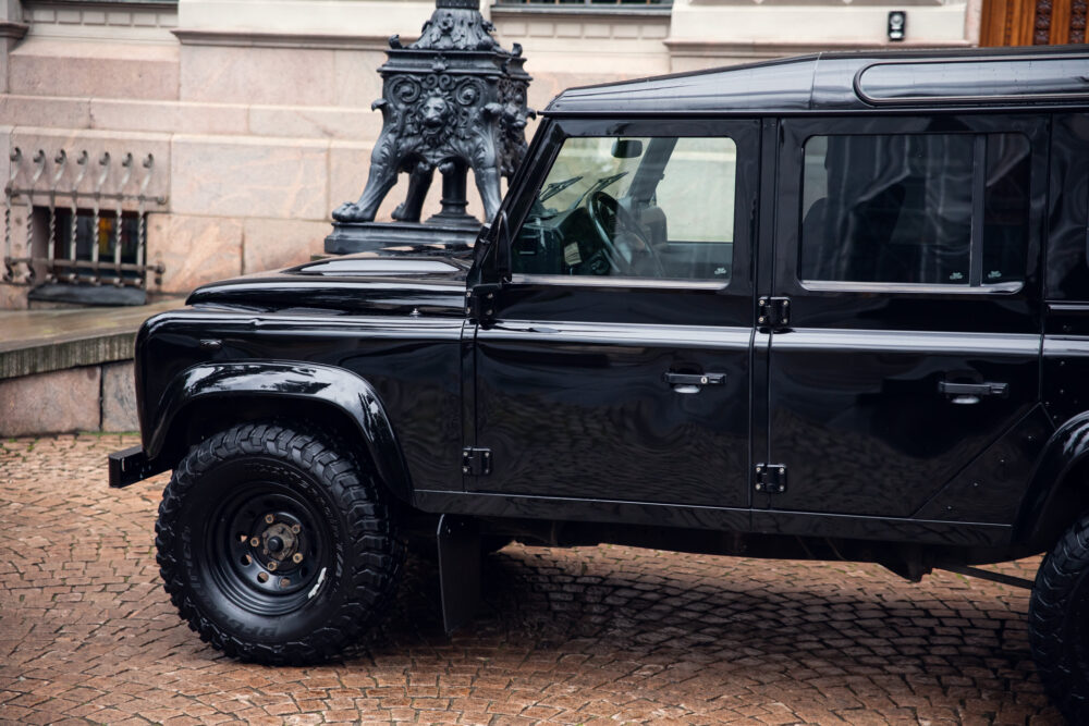 Black SUV parked near ornate bronze statue