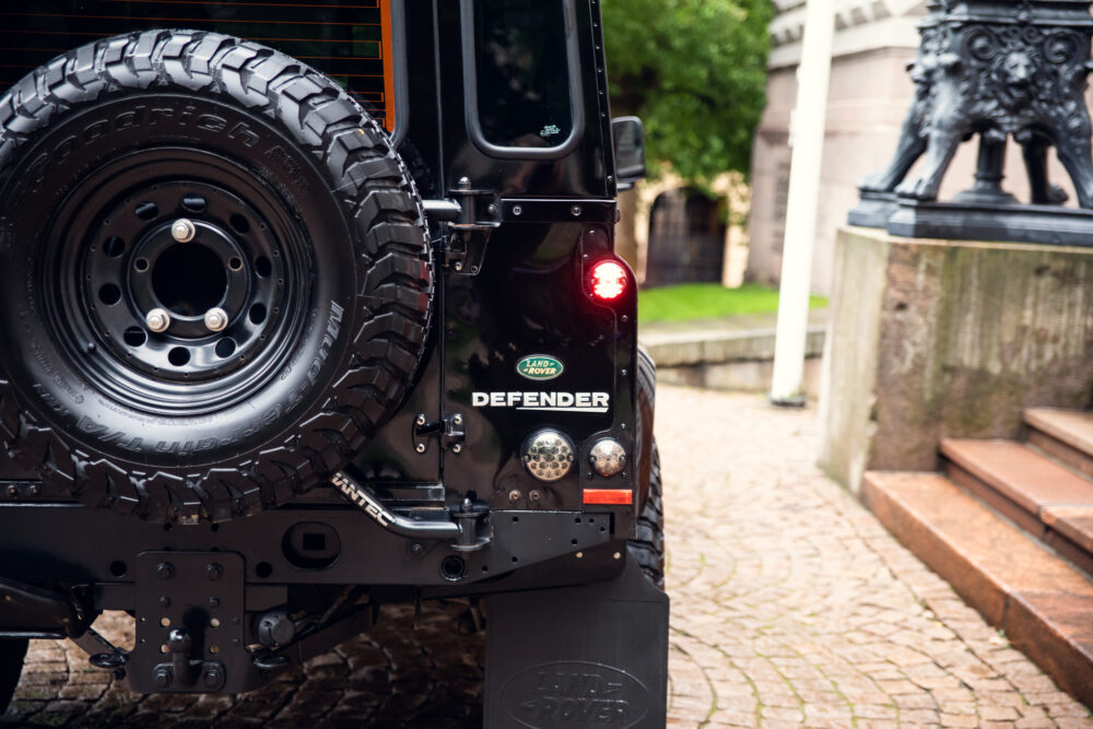 Rear view of a Land Rover Defender with spare tire
