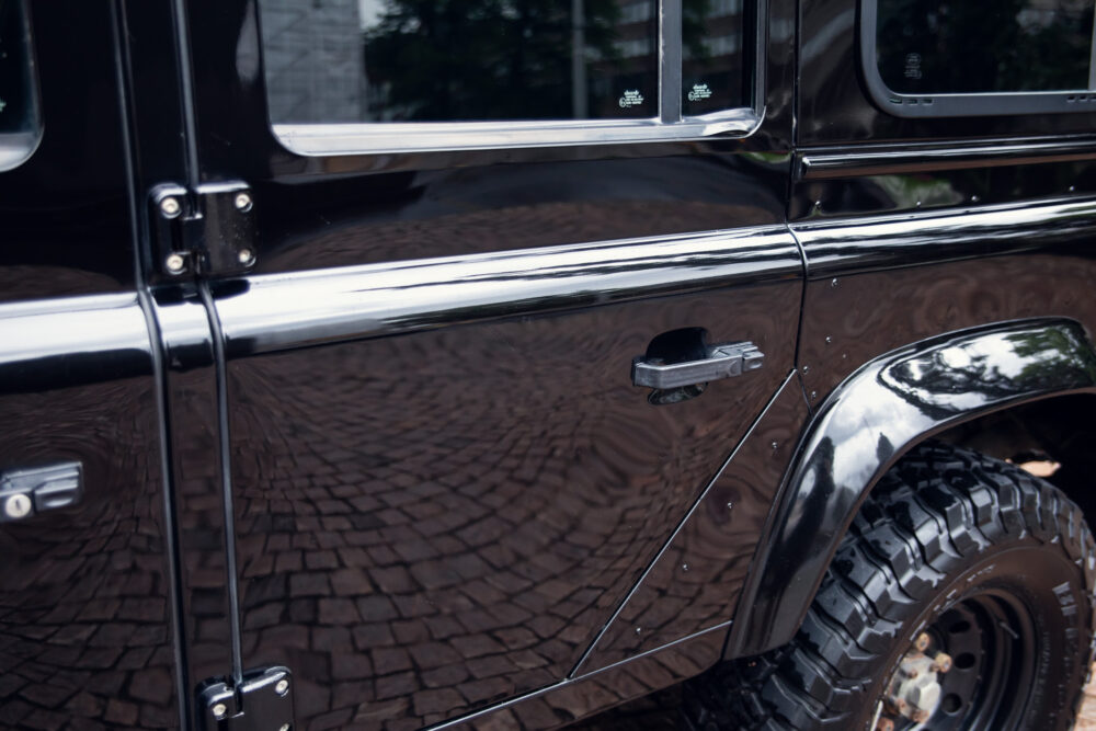 Close-up of black SUV door and polished chrome details
