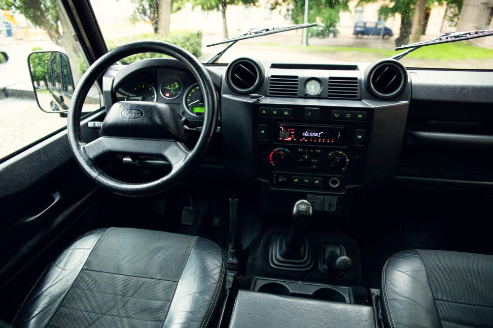 Interior view of a Land Rover with dashboard and wheel
