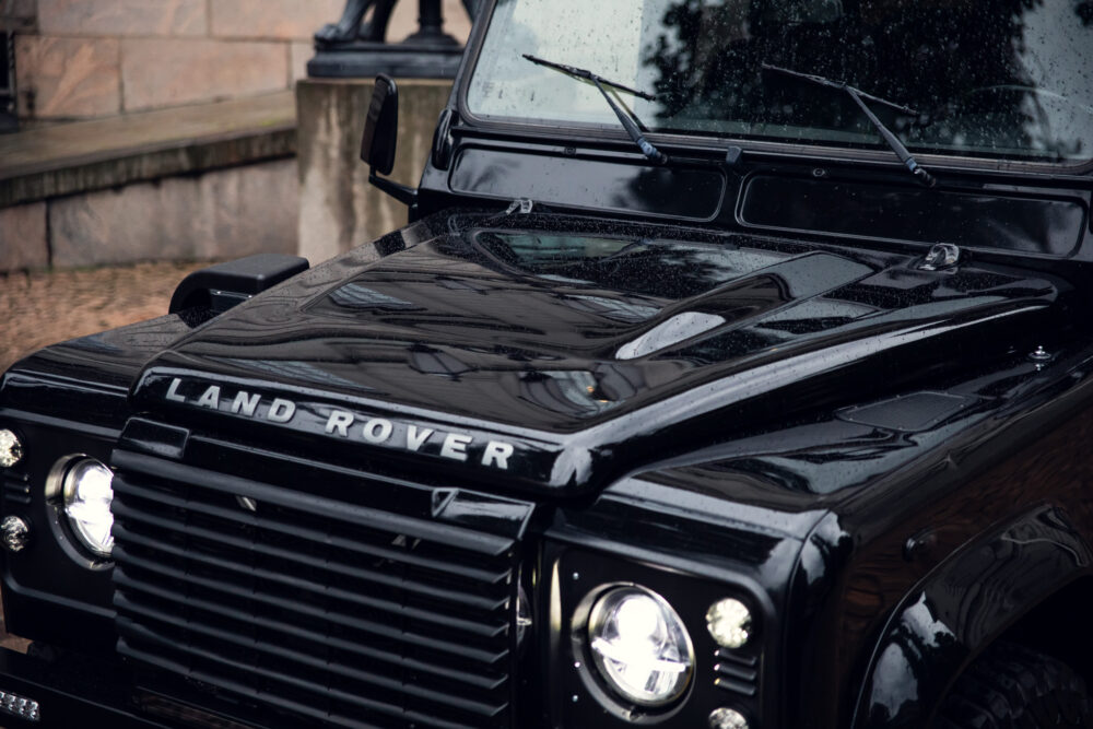 Wet black Land Rover vehicle on a rainy day