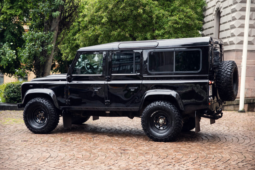 Black off-road vehicle parked on cobblestone street