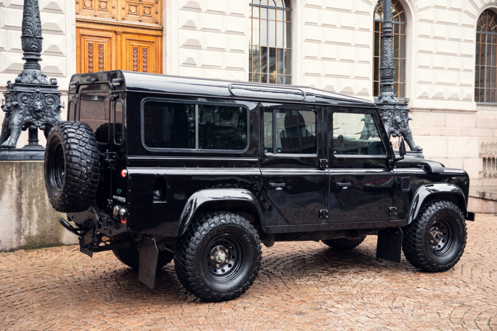 Black off-road SUV parked near historic building