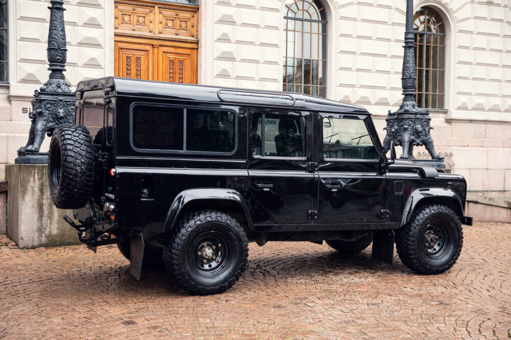 Black SUV parked near historical building entrance