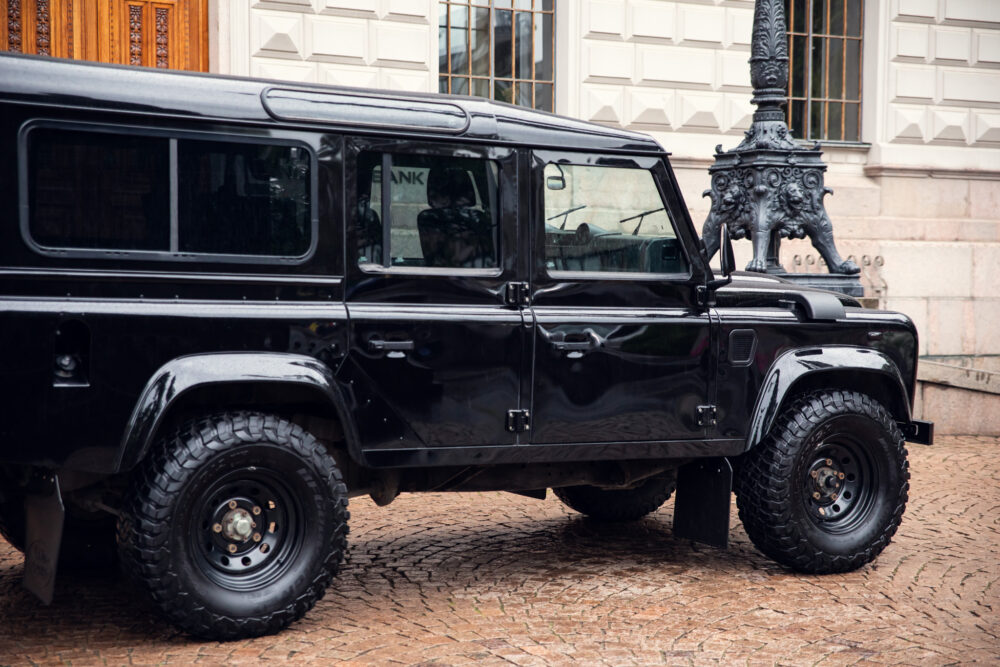 Black Land Rover Defender parked near ornate street lamp