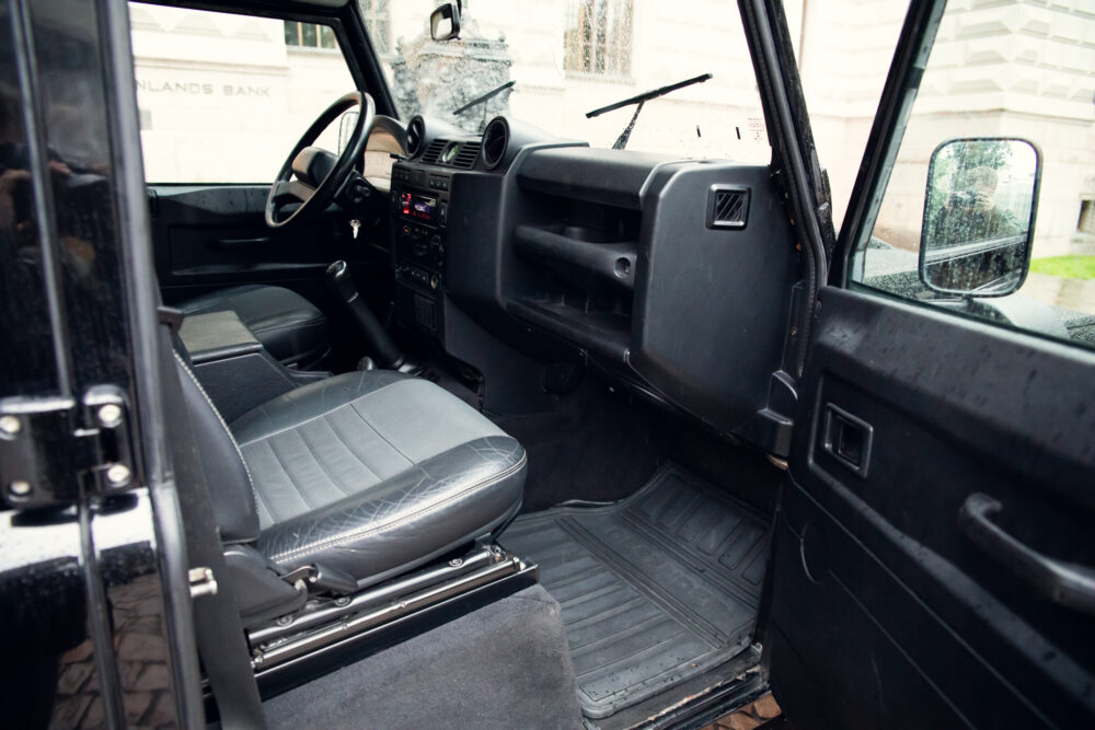 Interior view of vintage black SUV with open door