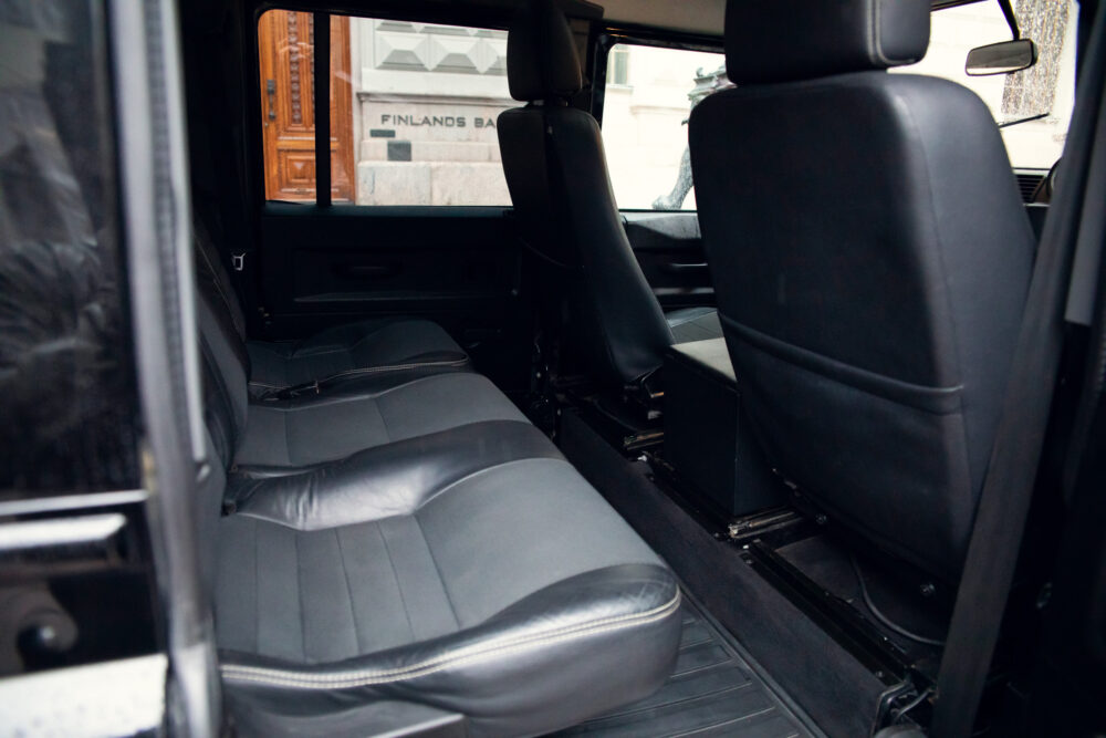Interior view of an empty black car with open door