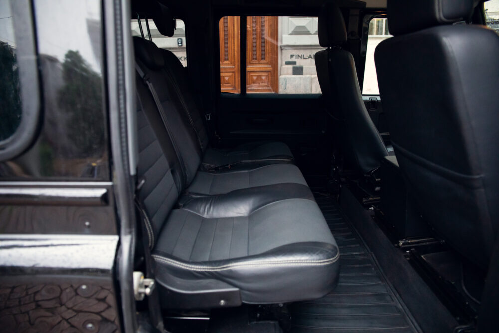 Interior view of a spacious black van with leather seats