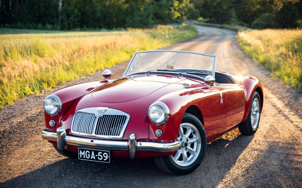 Vintage red MG convertible on countryside road