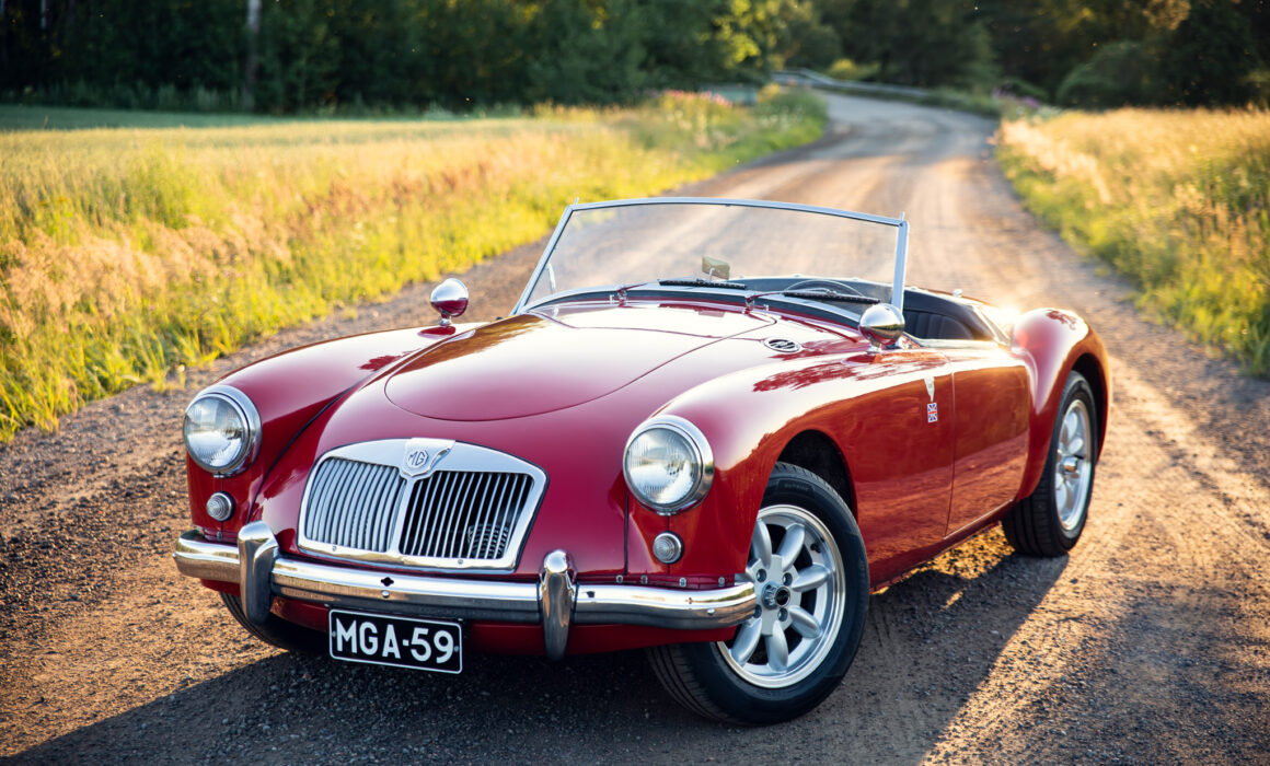 Vintage red MG convertible on countryside road