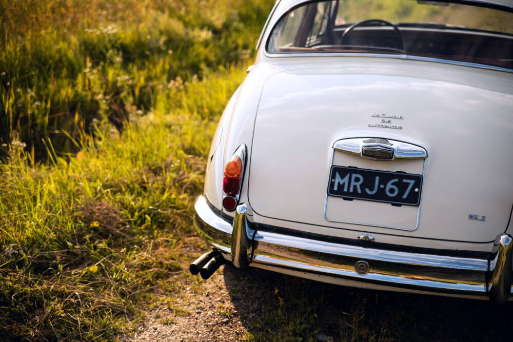 Vintage Jaguar MK2 car in lush green field