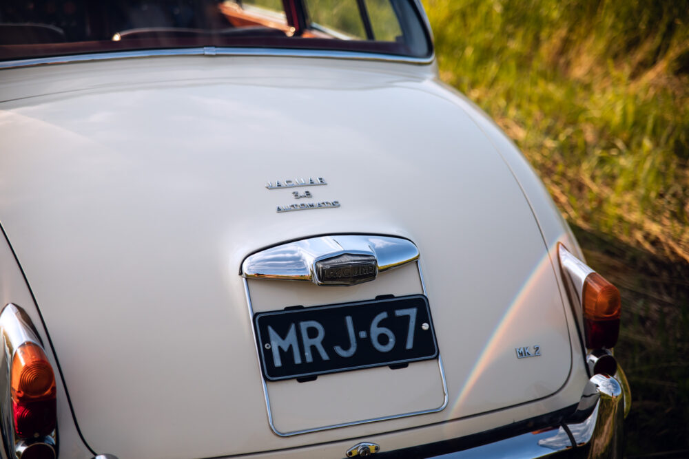 Vintage Jaguar MK2 rear view on grassy field