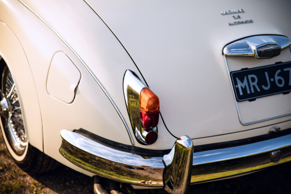 Vintage Jaguar car taillight and chrome bumper detail