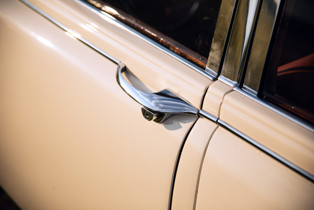 Close-up of vintage car door handle and trim