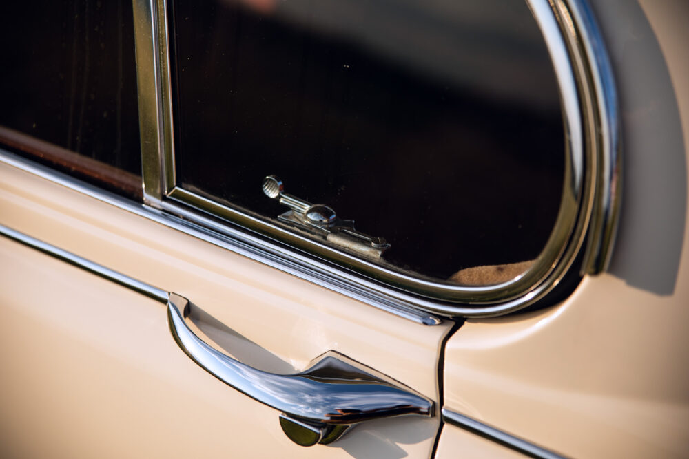 Close-up of vintage car door and shiny chrome handle
