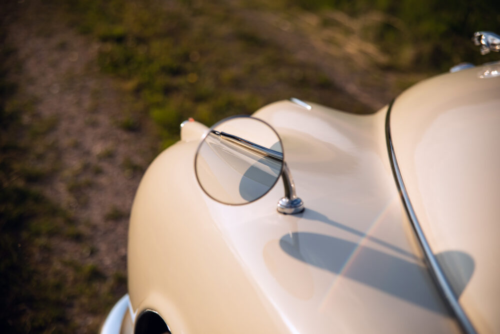 Vintage car's rear with shiny chrome rearview mirror